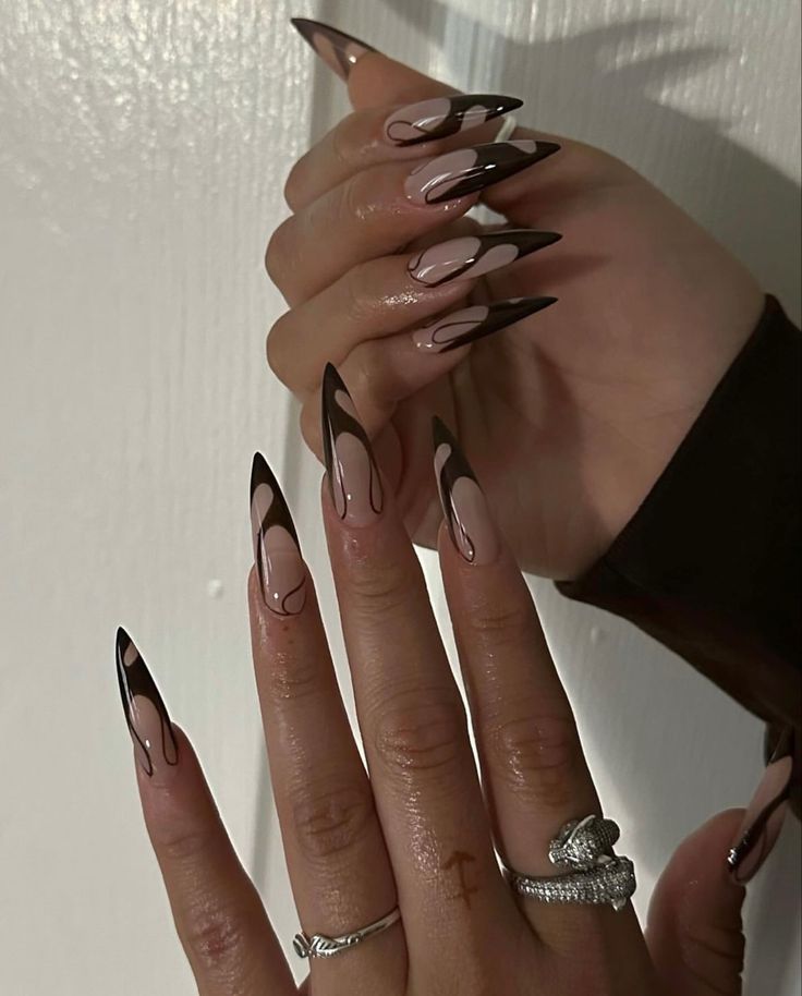 Bold Black and Nude Stiletto Nails: A Modern Twist on Classic Nail Art.