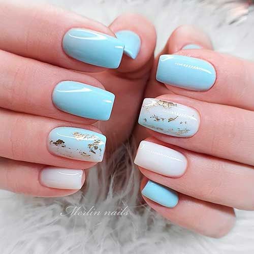 Elegant Blue Nail Design with Glossy and Matte Finishes Accented by Delicate Gold.