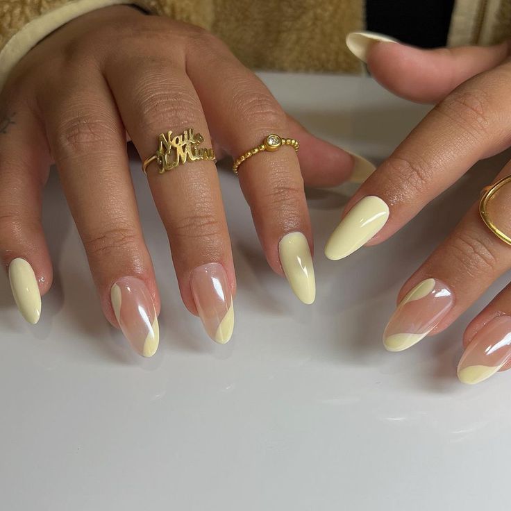 Chic Almond-Shaped Nails: Soft Yellow Hue and Clear Base for a Sophisticated Look.