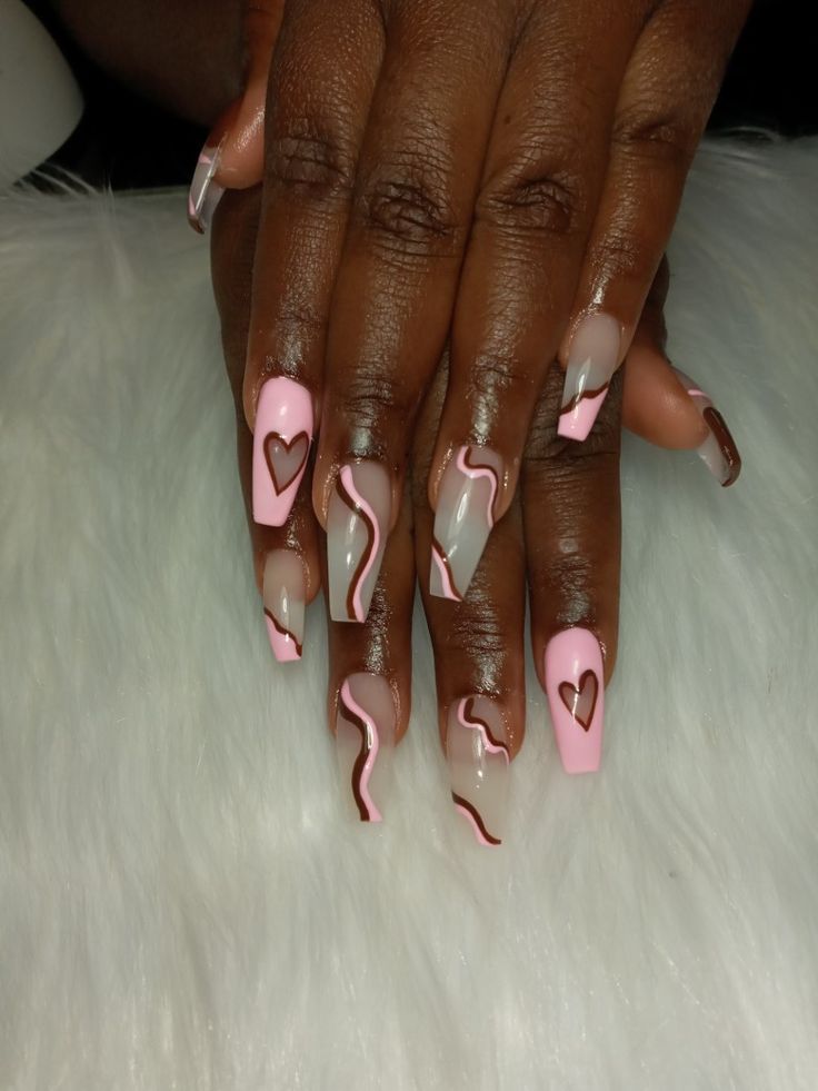 Elegant Nail Design: Soft Pink and Nude Shades with Charming Patterns and Glossy Finish