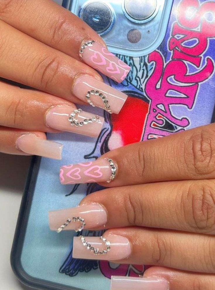 Trendy Chic Nail Design: Soft Pink and Nude with Heart Patterns and Silver Chains