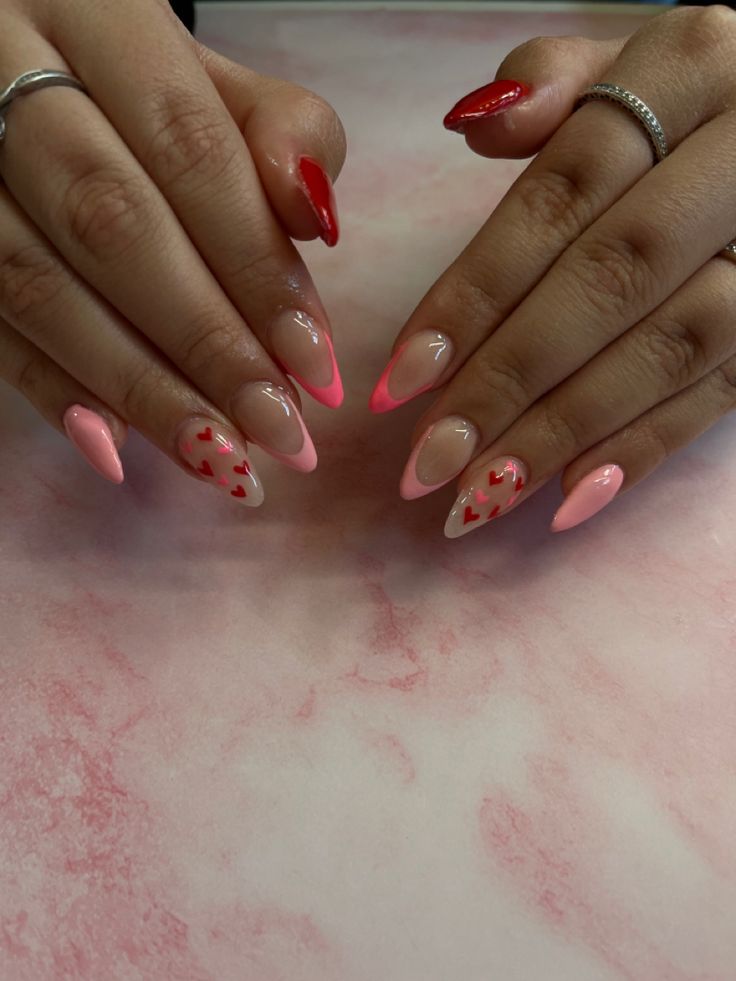 Chic Pink and Nude Nail Design with Vibrant Red Tips and Heart Motifs