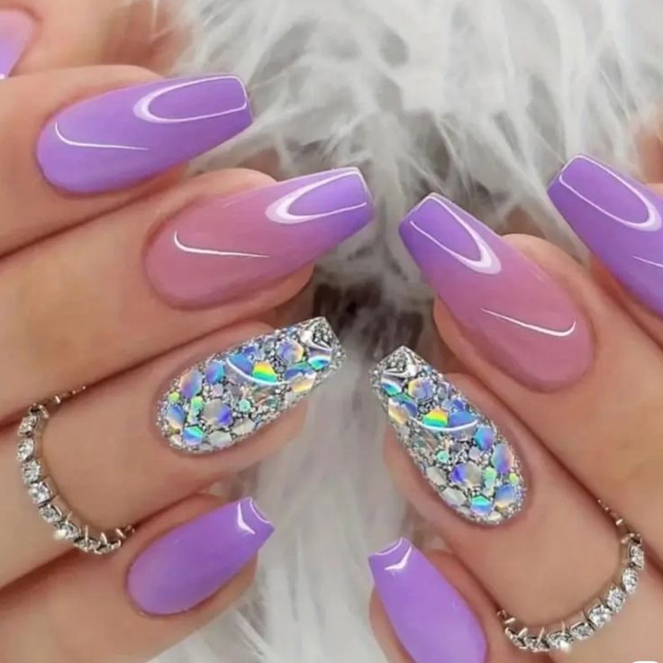 Elegant Lavender Ombre Nails Enhanced by Jewel-Toned Rhinestones for a Glamorous Touch.