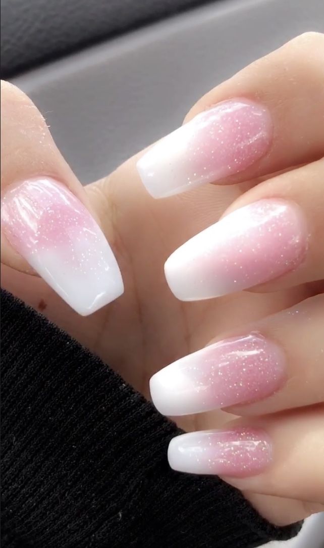 Elegant Ombre Nail Design: Soft Pink to Crisp White with Sparkling Accents.