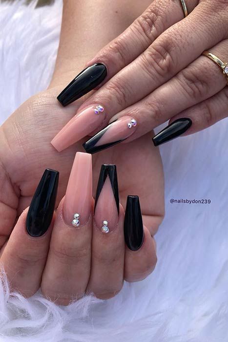 Bold Black and Nude Nail Design with Angular Shapes and Glamorous Rhinestones.