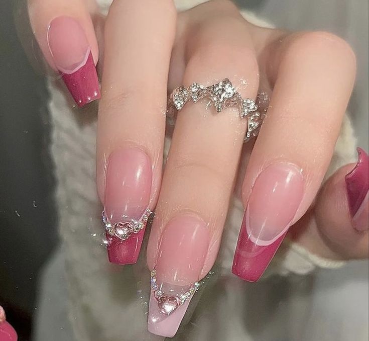 Sophisticated Gradient Pink and Nude Nail Design with Glamorous Embellishments.