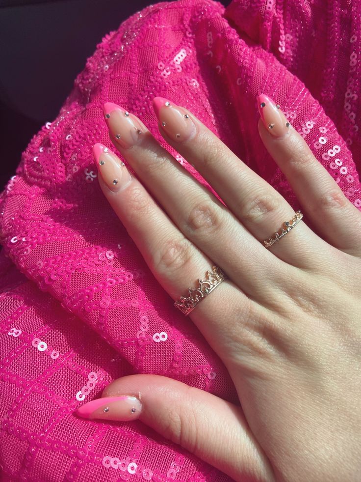 Sophisticated Almond-Shaped Nail Design: Soft Pink Base with White Tips and Rhinestone Accents.