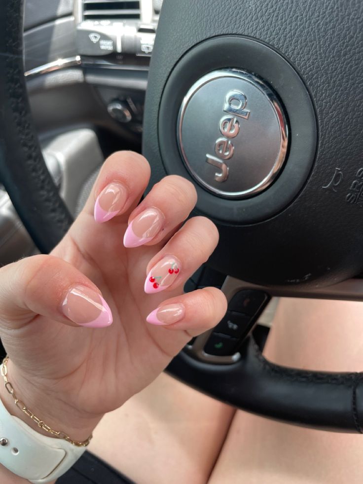 Chic Soft Pink French Tip Nails with Whimsical Cherry Accents.