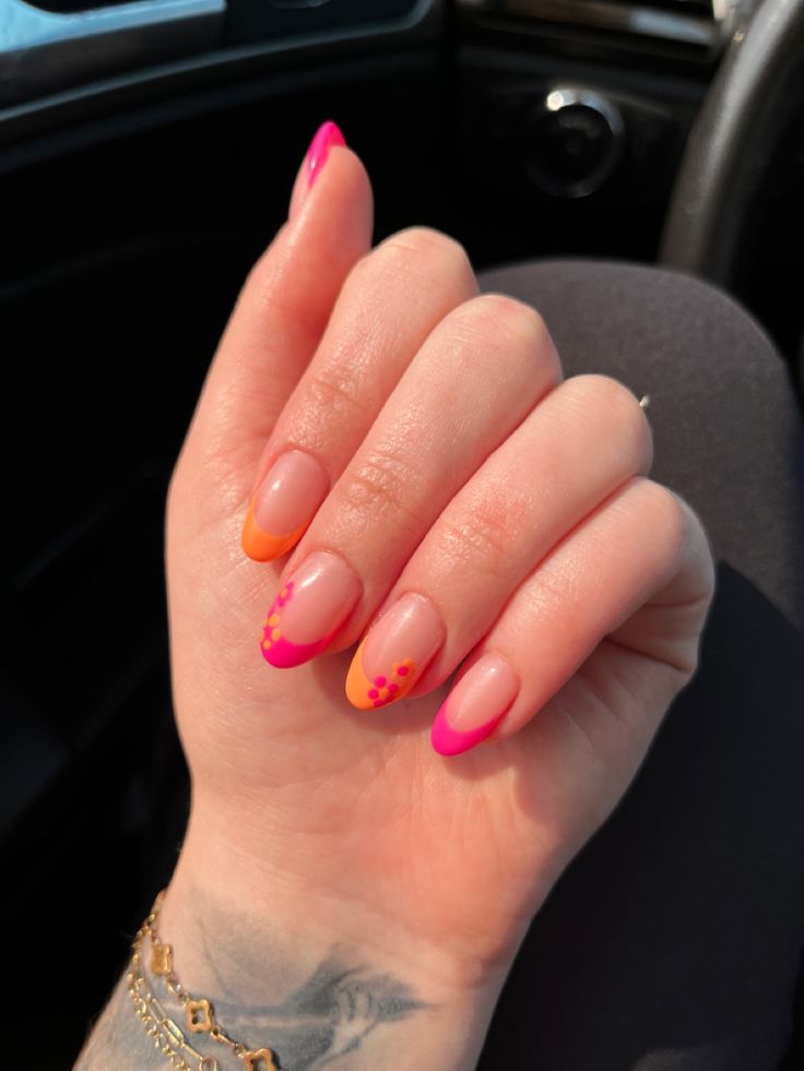 Playful Pink and Orange Ombre Nail Design with Fun Dotted Accents.