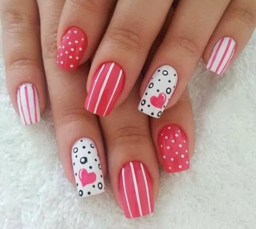 Playful Pink and White Nail Design with Cheerful Patterns for Special Occasions.