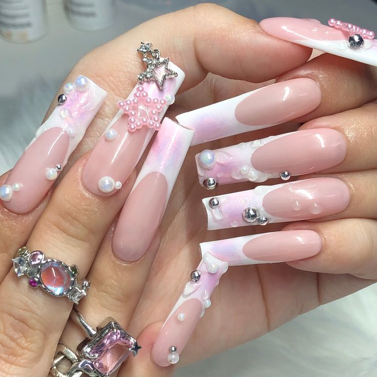 Whimsical Soft Pink Nail Design with Playful Embellishments and Glossy Finishes.