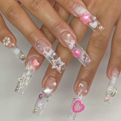 Whimsical Long Clear Tip Nail Design Adorned with Colorful Gems and Charms