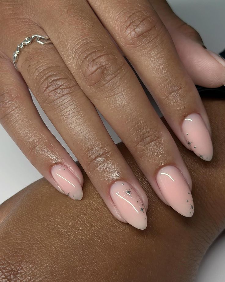 Chic Almond-Shaped Nails with Soft Pink Gradient and Whimsical Silver Stars.