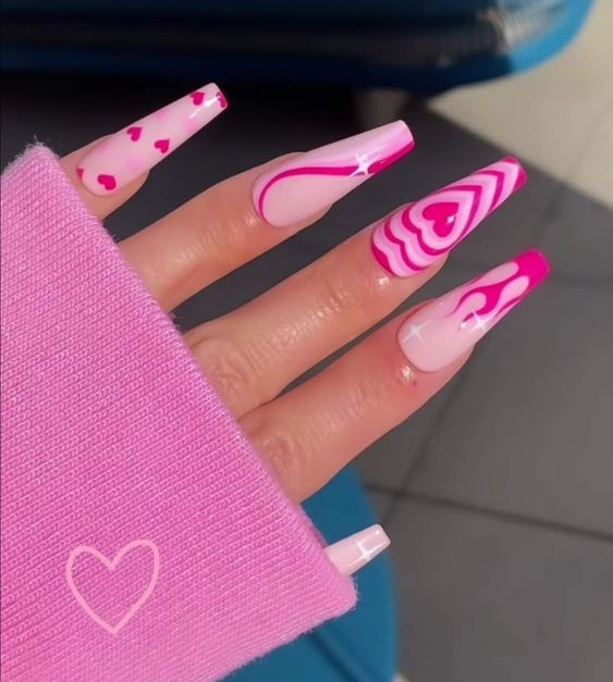 Vibrant Pink Nail Design with Playful Heart Motifs and Unique Patterns