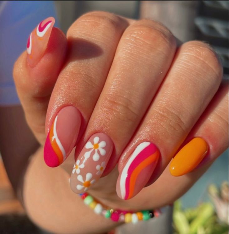 Playful Summer Nail Design with Colorful Patterns and Floral Motifs.