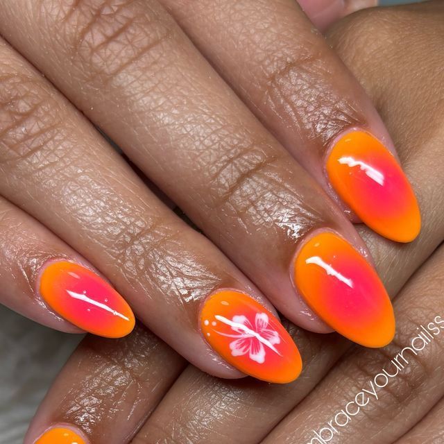 Tropical Vibes: Striking Orange and Pink Ombre Nails with Delicate Floral Accents