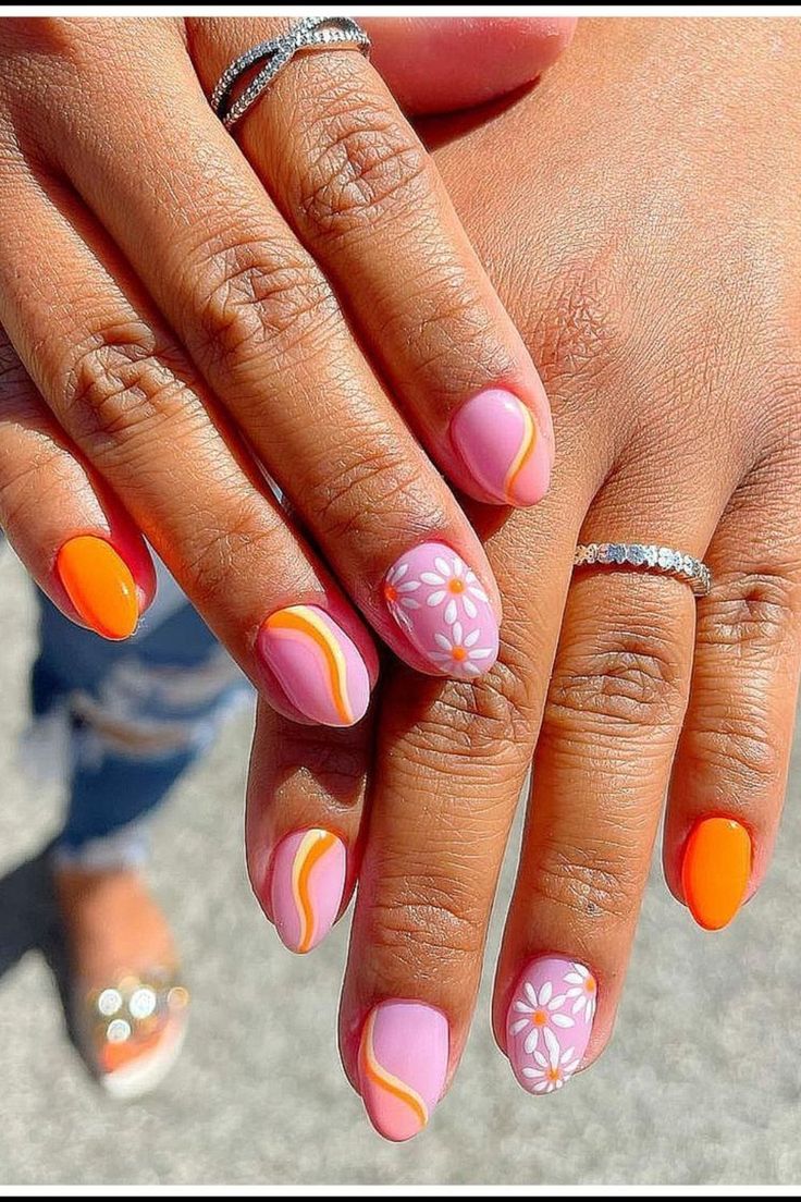 Playful Pastel and Bold Orange Nail Design with Floral Accents