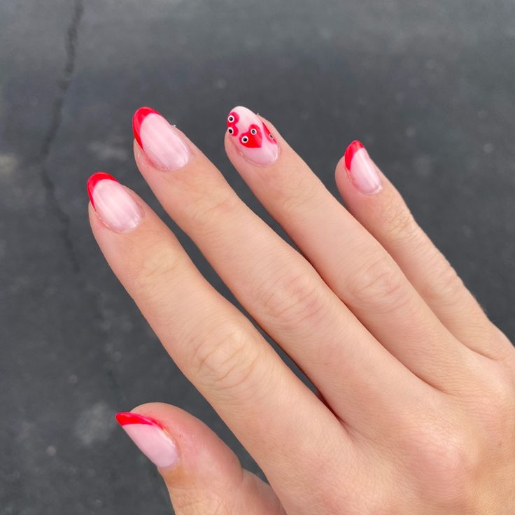 Charming French Tip Nail Design with Bold Red Edge and Whimsical Heart Accents.