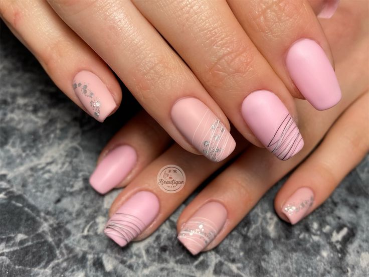 Chic and Sophisticated Soft Pink Nail Design with Matte Finish and Silver Accents