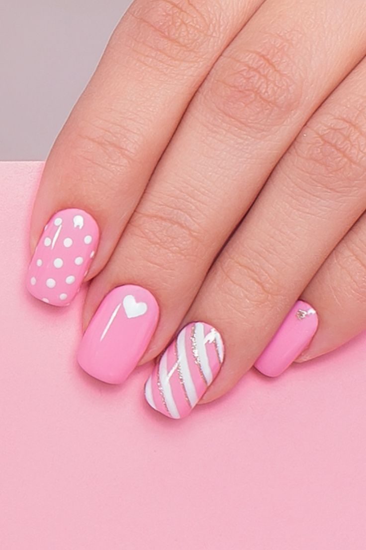 Whimsical Pink Nail Design with Patterns, Polka Dots, Hearts, Stripes, and Shimmer.