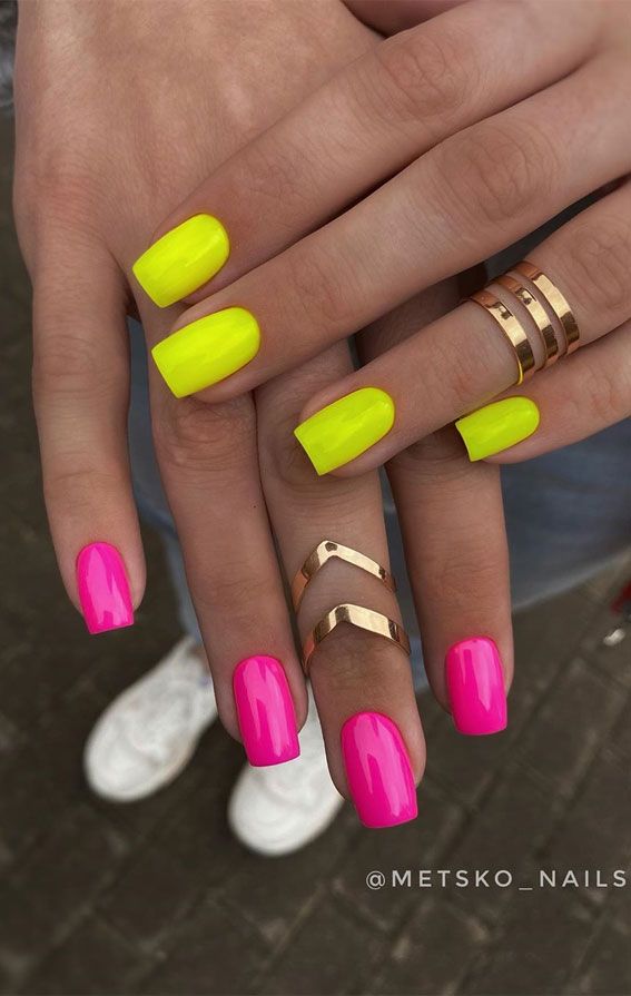 Striking Neon Pink and Yellow Nail Design Accentuated with Elegant Golden Rings.