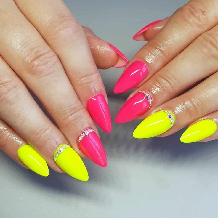 Bold Stiletto Nail Design with Hot Pink, Neon Yellow, and Glitter Accents.