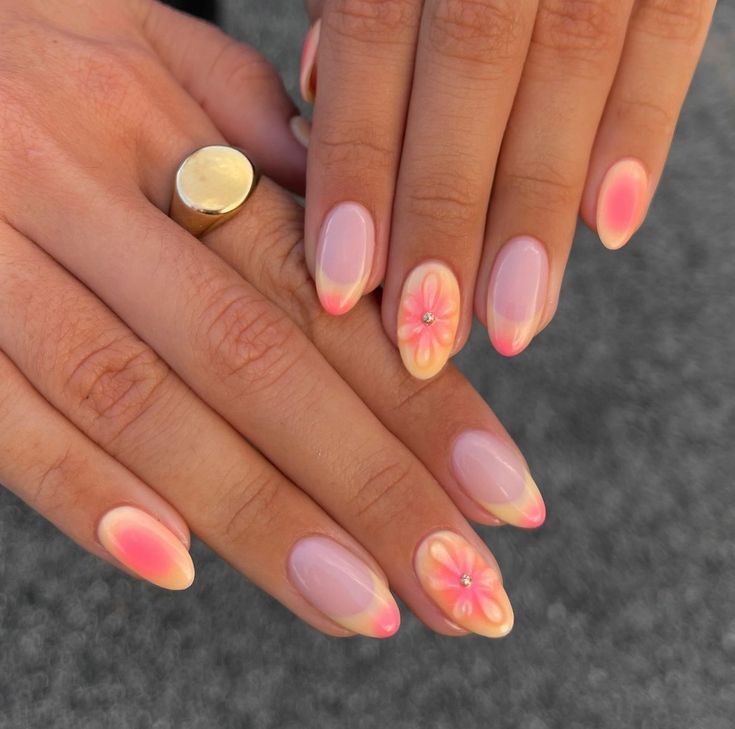 Elegant Soft Pink Ombre Nail Design with Floral Art and Gem Embellishments