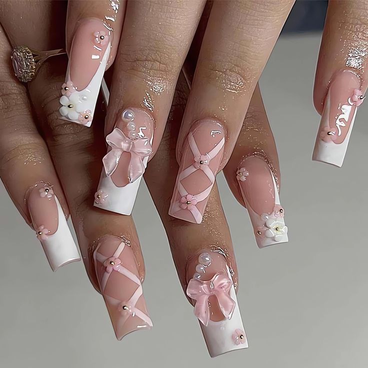 Whimsical Pink and White Nail Art with Intricate Designs and Elegant Pearl Accents.