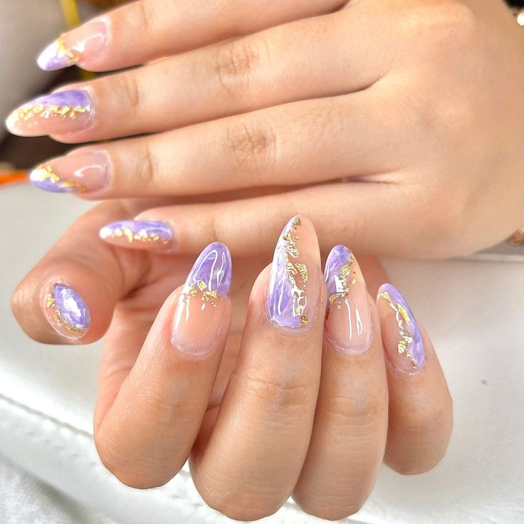 Sophisticated Soft Purple Nail Design with Clear Tips and Gold Foil Accents.