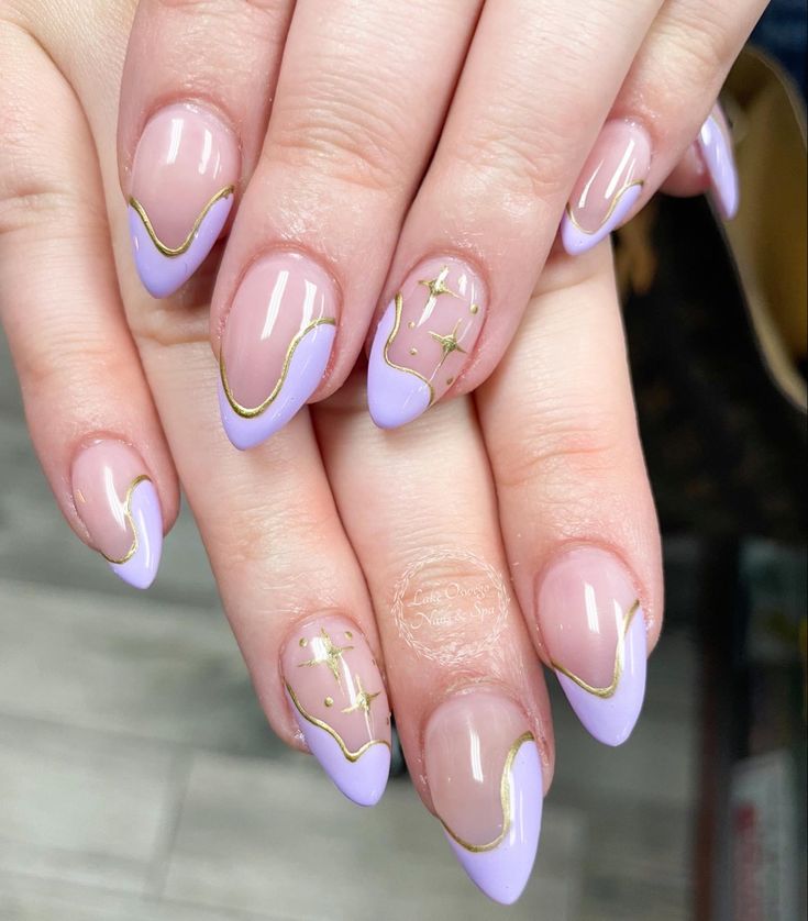 Sophisticated Lavender Nail Design with Glossy Finish, Pointed Tips, Gold Detailing, and Sparkling Star Embellishments.