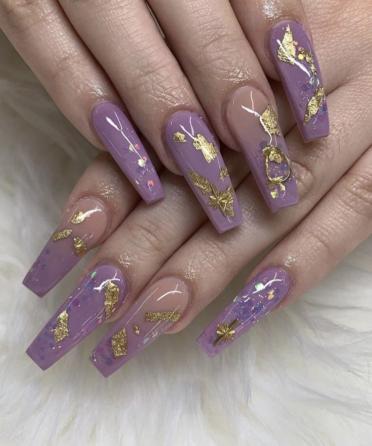 Stunning Long Lavender Nails Enhanced with Gold Leaf Accents for a Bold and Elegant Look.