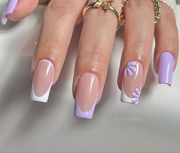 Chic Lavender and Nude Nail Design with Floral Accents and Stylish Tip Shapes.