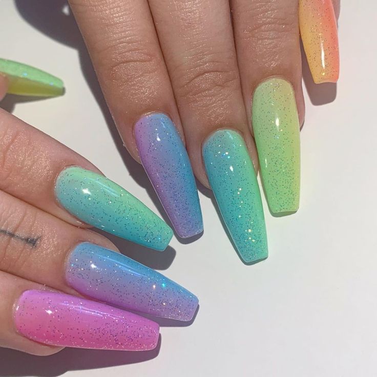 Playful Pastel Ombre Nail Design with Sparkling Gradient Effects for Summer.