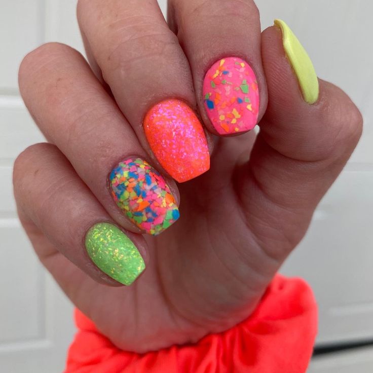 Vibrant Nail Design: A Festive Fusion of Bright Colors and Dynamic Textures with Glitter Accents.