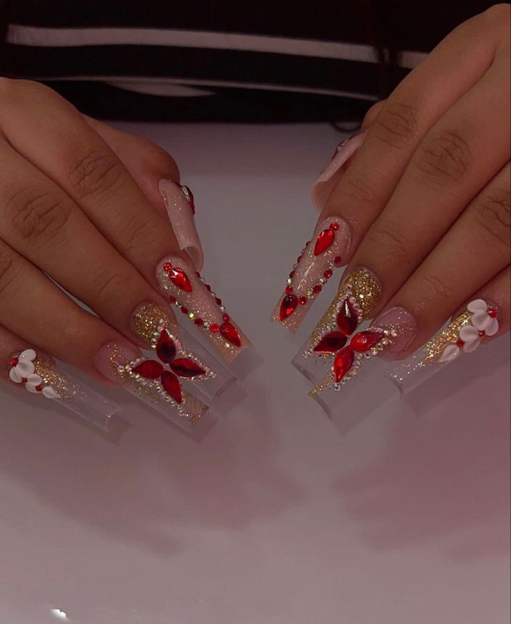 Luxurious Ombre Acrylic Nail Design with Floral Patterns and Gem Accents.