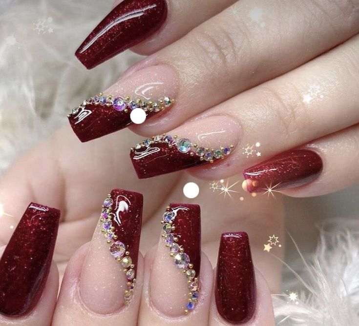 Elegant Shimmering Red and Nude Ombre Nails Adorned with Sparkling Rhinestones.