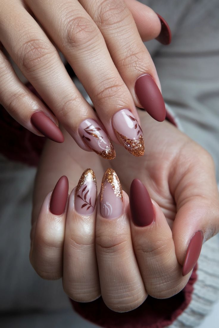 Sophisticated Nail Design: Burgundy Tips, Nude Hues, and Glittery Leaf Patterns