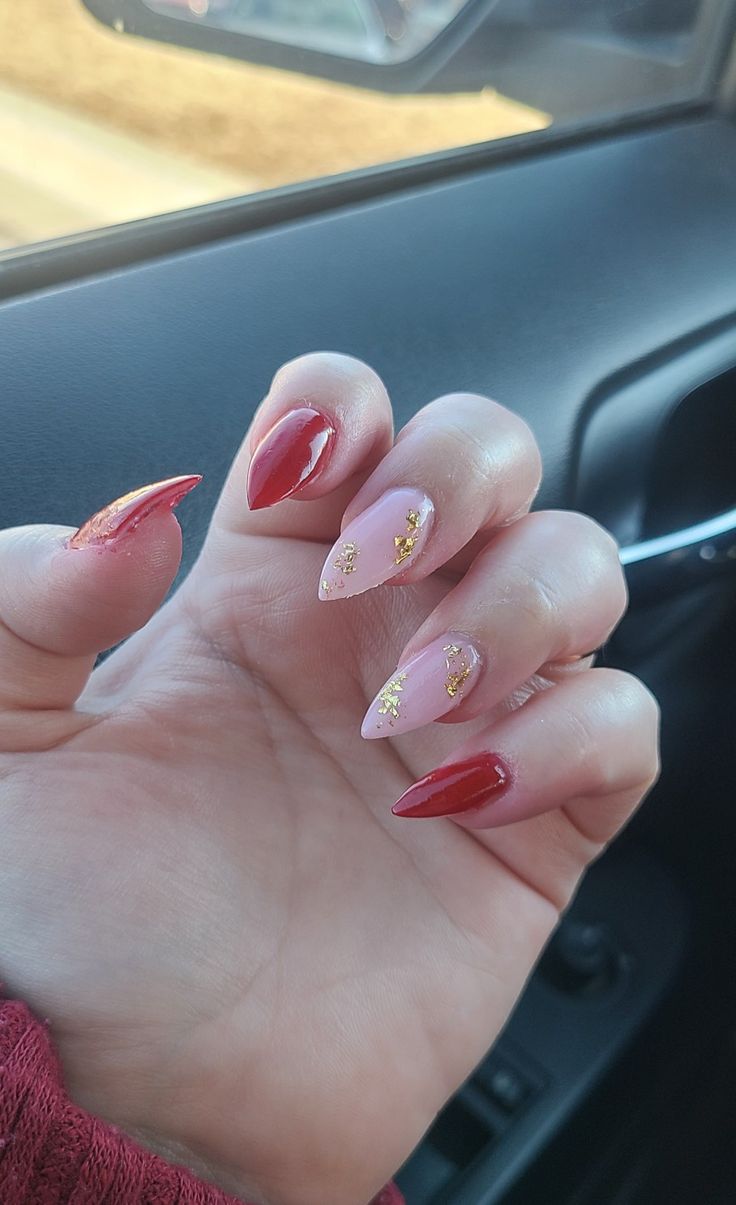 Sophisticated Almond-Shaped Nail Design with Deep Red and Soft Pink Shades Accented by Gold Leaf.