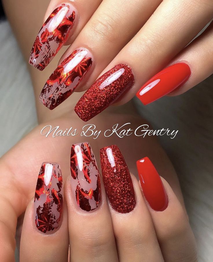 Bold Red Nail Art: A Vibrant Mix of Glossy and Textured Finishes with Intricate Abstract Patterns.