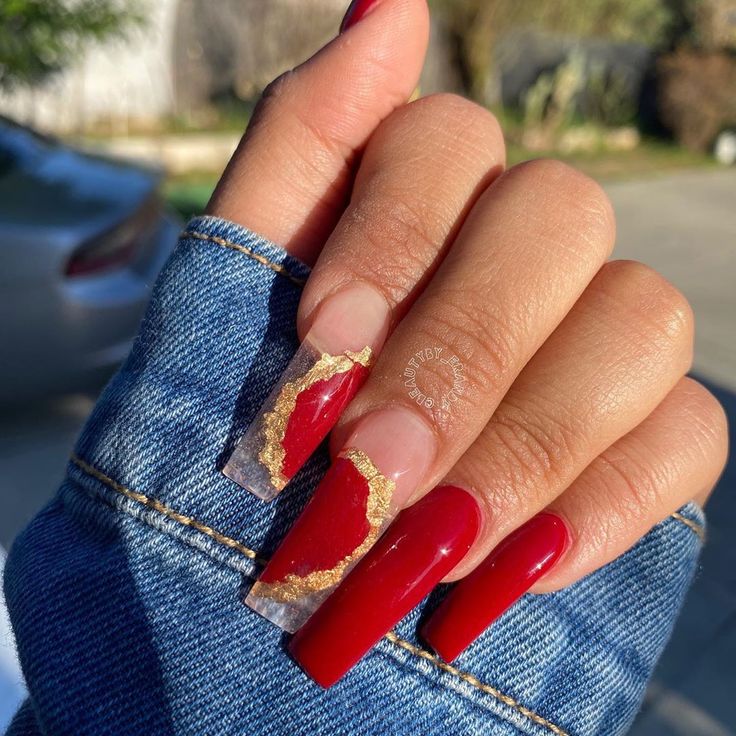 Bold Red and Translucent Nail Design with Elegant Gold Accents.