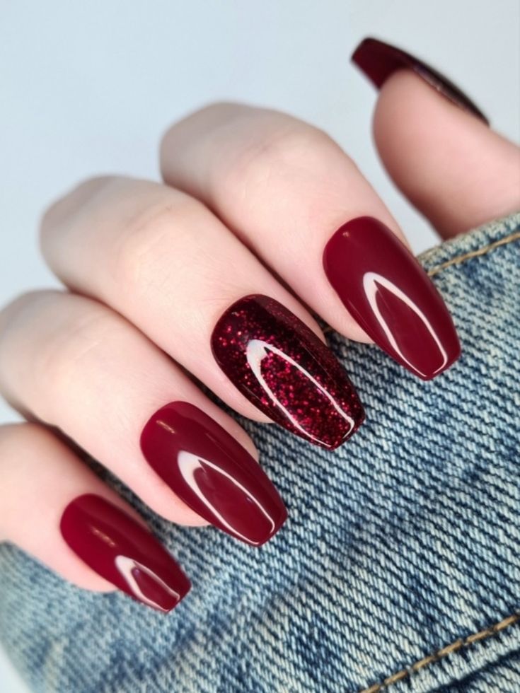 Chic Maroon Nails with Glittery Accent: A Glamorous Manicure Design.