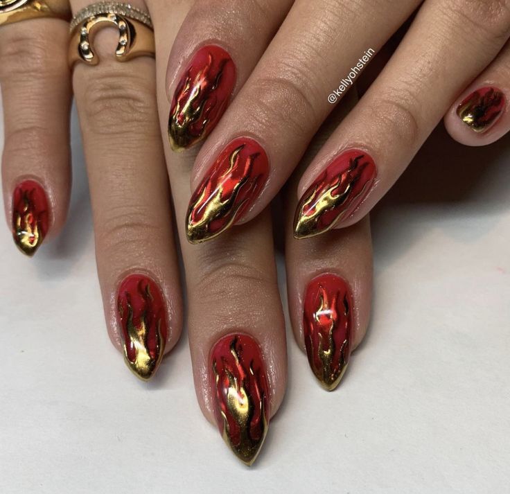 Fierce Flame-Inspired Nail Design with Bold Red Base and Gold Accents.