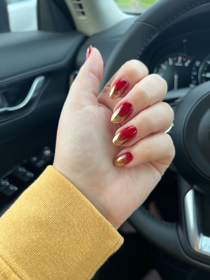 Chic Almond Nail Design: Deep Red and Shimmering Gold Gradient for Sophisticated Elegance.