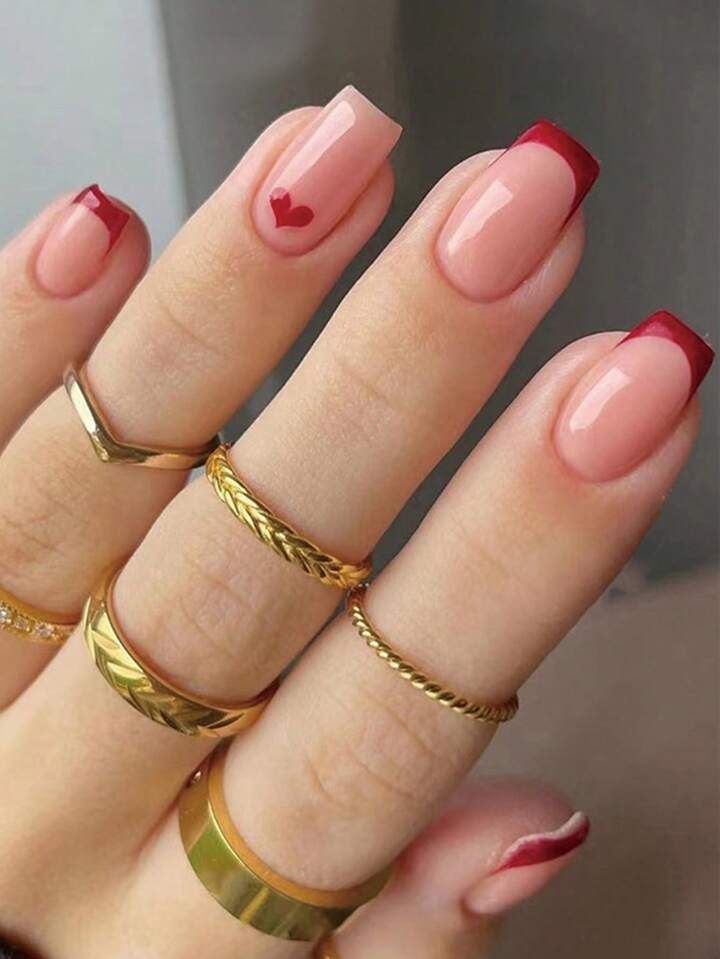 Elegant Pink and Red Heart Nail Design with Gold Accent Rings.