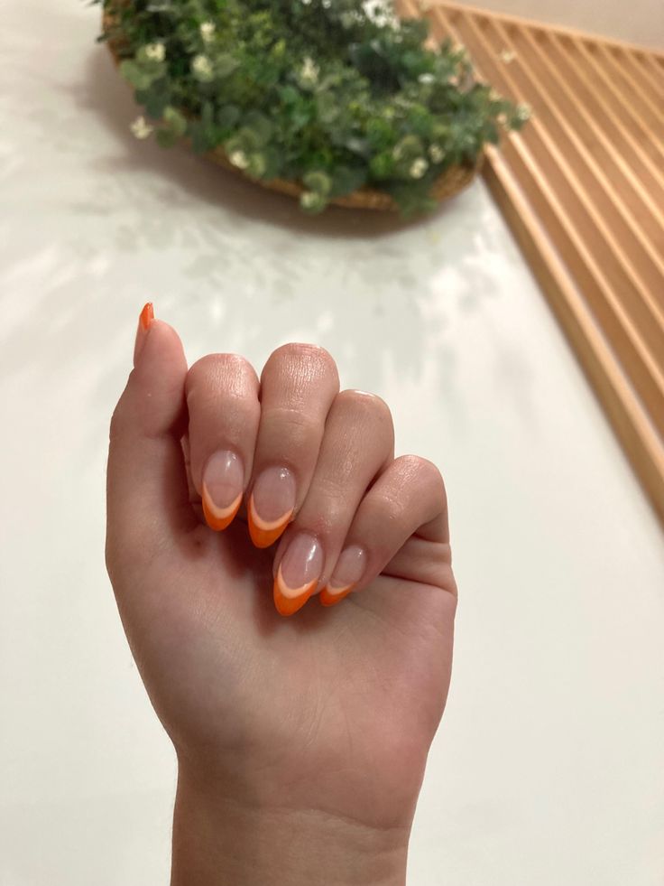 Chic Vibrant French Tips: Elegant Orange-Capped Nails with a Modern Flair.