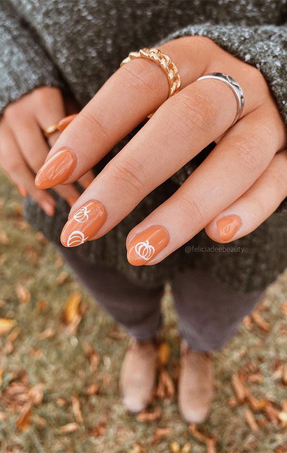 Cozy Autumn Nail Design: Warm Orange Base with White Pumpkin Art