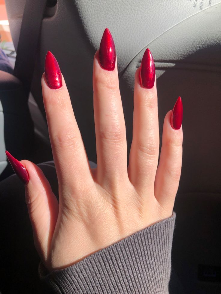 Elegant Red Stiletto Nails: A Striking Blend of Gloss and Sophistication.