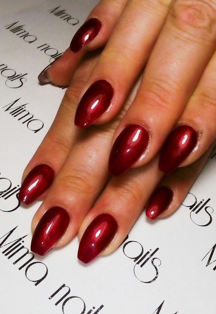 Sophisticated Glossy Almond Red Manicure: A Bold Choice for Elegance.