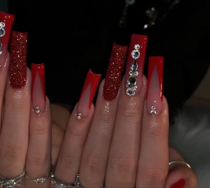 Glamorous Red Coffin Nail Design with Glossy, Glitter, and Rhinestone Accents.