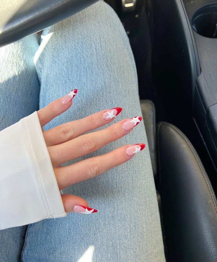 Sophisticated Red and White Almond-Shaped Nails with Playful Star Accents.